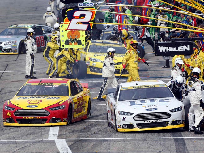 Joey Logano (22) pulls out of the pits ahead of Brad Keselowski (2) during Sunday's race in Loudon, N.H.