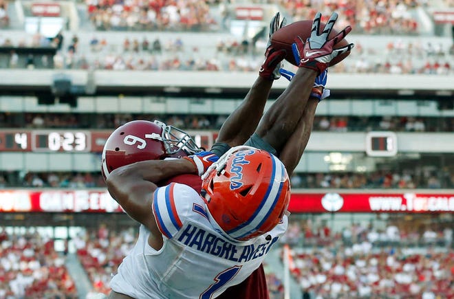 Alabama wide receiver Amari Cooper (9) scores a touchdown against Florida cornerback Vernon Hargreaves III (1) during the second half of an NCAA college football game on Saturday, Sept. 20, 2014, in Tuscaloosa, Ala.(AP Photo/Brynn Anderson)