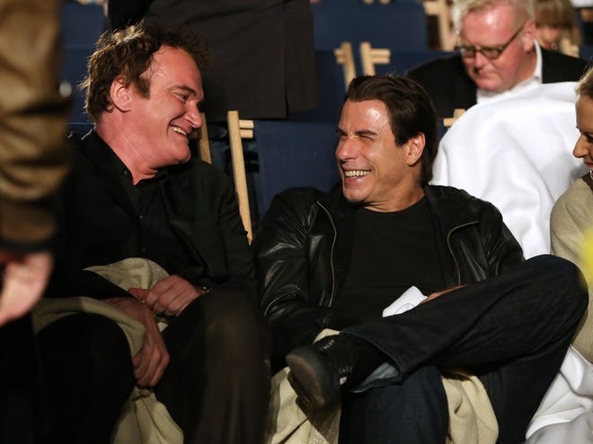 Quentin Tarantino and John Travolta speak to each other ahead of the beach screening of "Pulp Fiction" at Miramax's 20th Anniversary celebration of the film at Majestic Beach in Cannes, southern France, during the 67th international film festival on May 23.