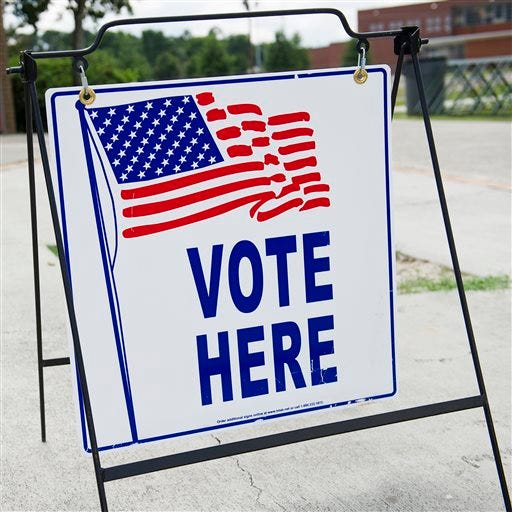 A "Vote Here" sign is seen outside the main entrance to the Fleming Park Bernie Ward Community Center during a run-off election day in Augusta, Georgia. (AP Photo/The Savannah Morning News, Sara Caldwell)