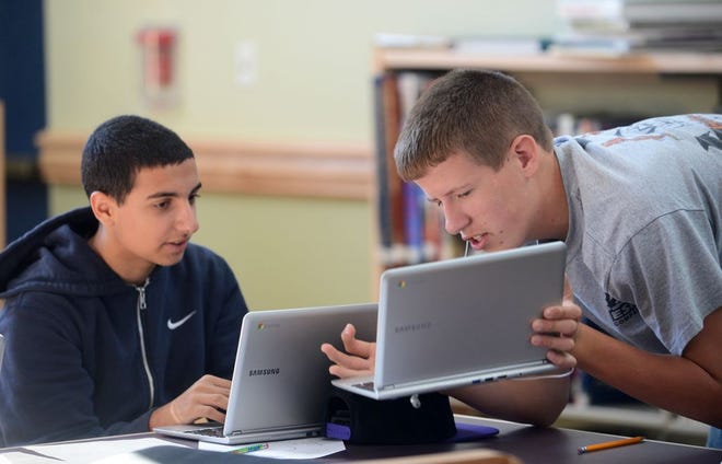 Kyle Backman of Stoughton, right, works on his Chromebook laptop computer with Michael Botaish, 16, of Sharon in September 2013 at Southeastern Regional Vocational Technical High School.