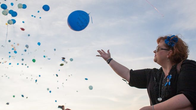 Ginny White-Peacock, of Austin, releases balloons during a memorial for Colton Turner at Milburn Park in Cedar Park on Sunday September 21, 2014. “I have a two-year-old so this hits home so much,” said White-Peacock. “Anything I can do to make his family feel better. The loss and the guilt are tremendous.” Colton would have turned three on Sunday.
