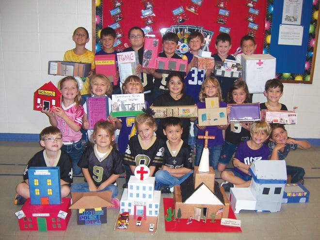 Dorothy Ledet's first-graders at Mulberry Elementary School in Houma recreated buildings found in the community during their two-week study of community helpers. The children were required to do oral presentations describing their buildings and tell the class the importance of the community helpers who work in that building. They are Alexander VanHoeven (front row, from left), Kristen Theriot, Addison Bergeron, Samuel Duet, Paxton Fortenberry and Hannah Henley; Madison Marcel (middle row, from left), Makaila Marcel, Ava Favalora, Arianna Foret, Layla Domangue, Cali Messmer and Jayden Scott; and Jayce Cunningham (back row, from left), Liam Naquin, Dylan Landry, Landon Ledet, Levi Martin, Hunter Trahan, and Ethan Sun.