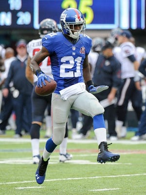 New York Giants cornerback Dominique Rodgers-Cromartie (21) celebrates after intercepting a pass against the Houston Texans in the fourth quarter of an NFL football game, Sunday, Sept. 21, 2014, in East Rutherford, N.J. (AP Photo/Bill Kostroun)