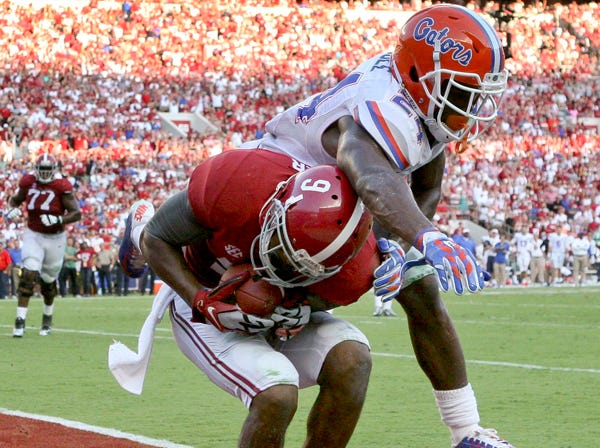 Alabama’s Amari Cooper catches a touchdown pass against the defense of Florida’s Brian Poole during Saturday’s 42-21 victory by the Crimson Tide. (Gary Cosby Jr. | Decatur Daily | Associated Press)