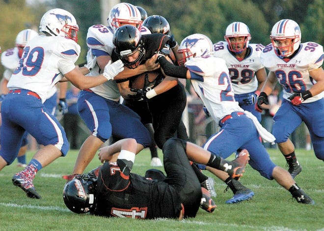 Dalton’s Jesse Mann tries to break through a gang of Tuslaw defenders during a 59-12 victory in Week 3. The Bulldogs have averaged 308.5 yards rushing a game during their 3-1 start.