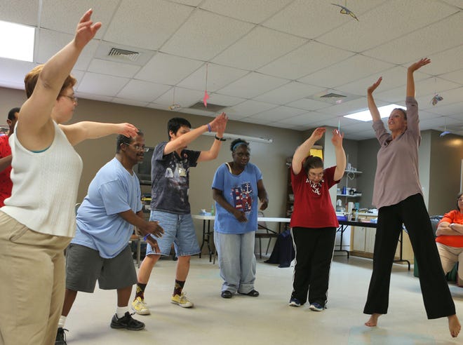 Volunteer dance instructor Tara Dent, right, leads a class Tuesday. The St. Andrew Center in Lynn Haven offers several programs for adults with mental disabilities.
