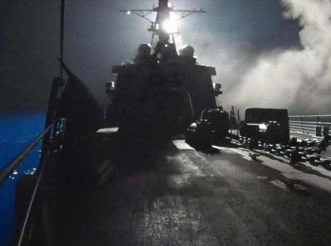 In this image made from video released by the U.S. Navy on Tuesday, missiles bound for Syrian Islamic State group targets are launched off of a U.S. Navy ship. U.S. officials said the airstrikes began around 7:30 p.m. CDT Monday and were conducted by the U.S., Bahrain, Qatar, Saudi Arabia, Jordan and the United Arab Emirates.