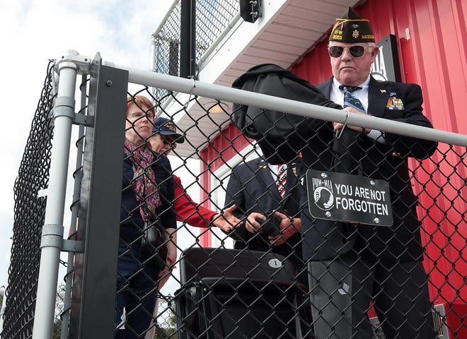 VFW Commander Dave Sargent unveils the sign for the POW/MIA chair at the sports complex on Saturday, September 20, 2014. Wicked Local Staff Photo by Robin Chan 2014