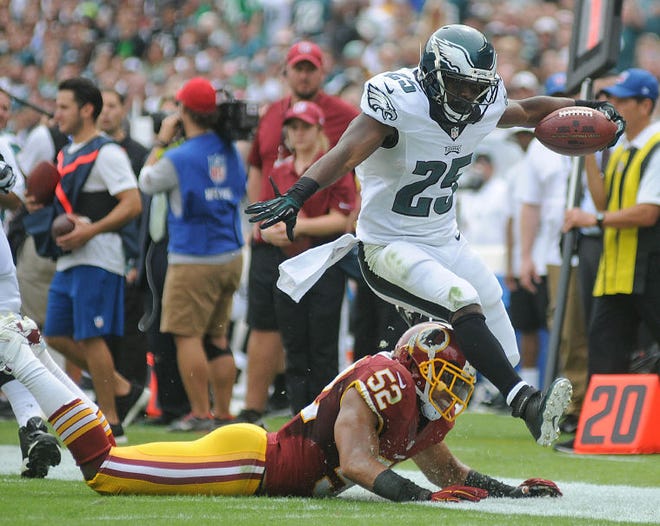 Eagles running back LeSean McCoy (25) leaps over Washington's Keenan Robinson (52) to stay in bounds during their game at Lincoln Financial Field on Sunday, September 21, 2014. The Eagles won 37-34 over Washington.