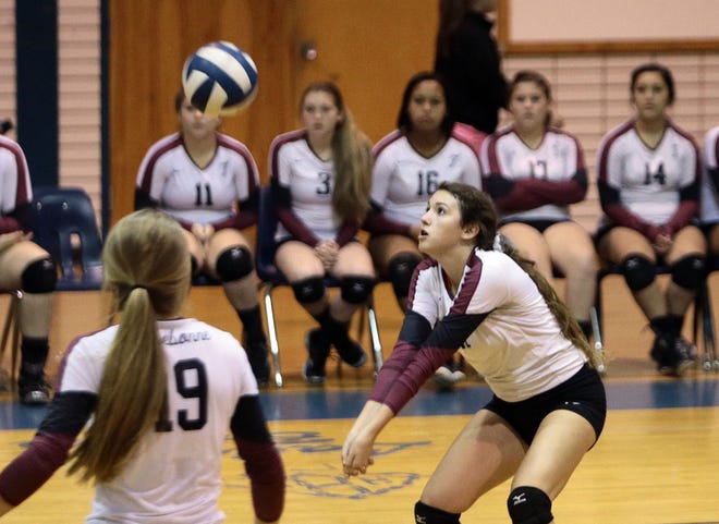 Terrebonne's Lillian Rodrigue (right) records a dig as teammate CeCe Hazard (19) looks on during Tuesday's District 5-I match against H.L. Bourgeois in Gray. Terrebonnne rallied to win in five games.