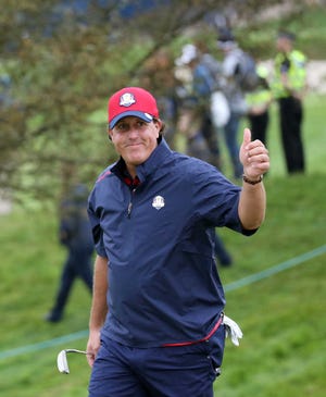 Phil Mickelson of the US gestures as he walks to the 7th green during a practice round ahead of the Ryder Cup golf tournament at Gleneagles, Scotland, Tuesday, Sept. 23, 2014. (AP Photo/Scott Heppell)