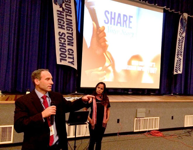 Burlington City High School Principal James Flynn and Rachel's Challenge presenter Eliana Reyes address 100 students and 25 staff members at the high school auditorium Thursday. The session was aimed at beginning a chain reaction of kindness and compassion in the school.