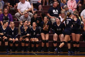 Members of the Monmouth-Roseville volleyball team watch the action during a victory over West Hancock on Thursday night.  RUTH KENNEY/REVIEW ATLAS