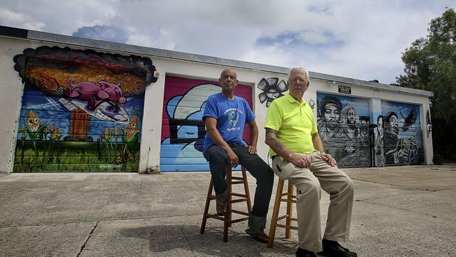Artists Rolando Chang Barrero (left) and Richard Beau Lieu sit in the midst of the Boynton Beach Art District on Aug. 30, 2014. Beau Lieu founded the district in the 1980s, and Barrero helped it to blossom beginning about four years ago. (Damon Higgins / The Palm Beach Post)