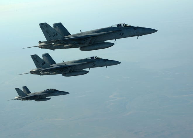 In this Tuesday, Sept. 23, 2014 photo released by the U.S. Air Force, a formation of U.S. Navy F-18E Super Hornets leaves after receiving fuel from a KC-135 Stratotanker over northern Iraq, as part of U.S. led coalition airstrikes on the Islamic State group and other targets in Syria.