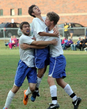 Somersworth’s Peter Drakopoulos, left, Hunter Michaud, center and Zach Hamilton celebrate Hamilton’s goal during the second half of Division III action against Raymond on Thursday.