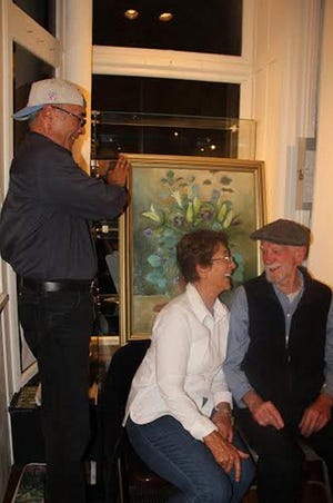 Artist Michele Jaffe with her longtime mentor Buzz Wallace, director of Orange County Community College art department when they met. Behind them, with Jaffe's oil painting, is Sam Liu.