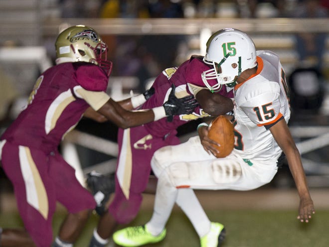 Eastside's Joseph Malu is tackled by two North Marion defenders. The Rams fell to the Colts 52-12.