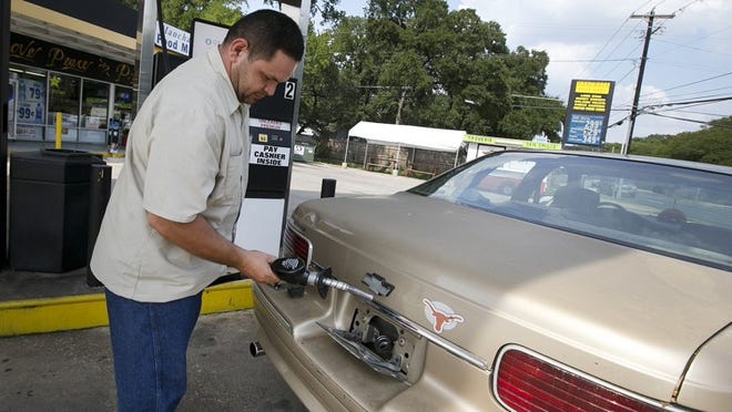 Joe Marciel puts gas into his car at the Manchaca Food Mart on Monday, September 22, 2014. Gas prices at some stations around Austin have dropped to below $3 per gallon.DEBORAH CANNON / AMERICAN-STATESMAN