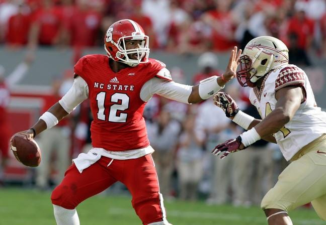 Florida State’s DeMarcus Walker rushes North Carolina State quarterback Jacoby 
Brissett during the first half in Raleigh, on Saturday.