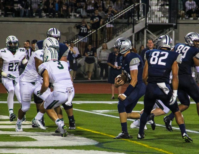 Quarterback Andy Vailas, center, scores on a 2-yard run during the University of New Hampshire's 52-19 win over Dartmouth at Cowell Stadium Saturday night. Photo by Shawn St.Hilaire.