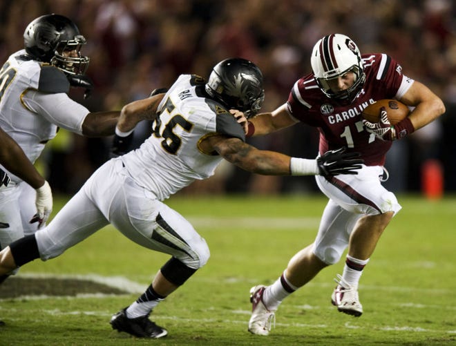 Missouri defensive end Shane Ray (56) tracks down South Carolina quarterback Dylan Thompson (17) for a sack in the first half of the Tigers’ 21-20 victory over the Gamecocks on Saturday night in Columbia, S.C. Ray had two sacks, and the defense kept MU close enough to rally from a 20-7 deficit with 7:25 remaining for a huge road victory in the SEC