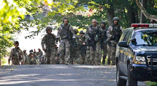 FBI along with various state police officers exit a wooded area at Buck Hill Falls in Barrett Township, where the search for Eric Frein continues Friday Sept 26, 2014.