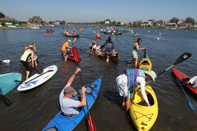 Contestants turn out on a warm September Sunday for the 24th annual Mist to Mews Canoe & Kayak Race. Above, they enter the water Sunday near the Ocean Mist in Matunuck, on their way to the Mews Tavern in Wakefield. The event benefits The Wounded Warrior Project.