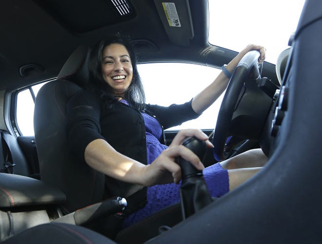 Marlo Dewing prepares to shift the manual transmission of her 2012 Volkswagen GTI into gear in Sacramento, Calif. When she wanted to replace her 22-year-old Mazda Miata, she had very few manual models to chose from.