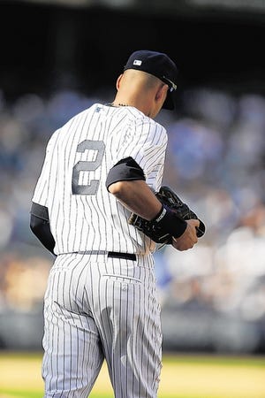 New York Yankees shortstop Derek Jeter (2) heads to his position in the eighth-inning of a baseball game against the Kansas City Royals at Yankee Stadium in New York, Sunday, Sept. 7, 2014. The Royals shutout the Yankees 2-0. (AP Photo/Kathy Willens)