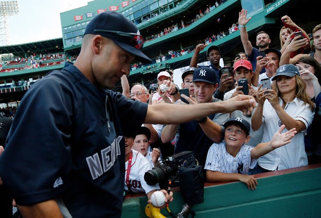 Fans greet New York Yankees' Derek Jeter as he leaves the field after the last baseball game of his career, against the Boston Red Sox Sunday, Sept. 28, 2014, at Fenway Park in Boston. Jeter had an RBI single in the Yankees' 9-5 win. (AP Photo/Elise Amendola)