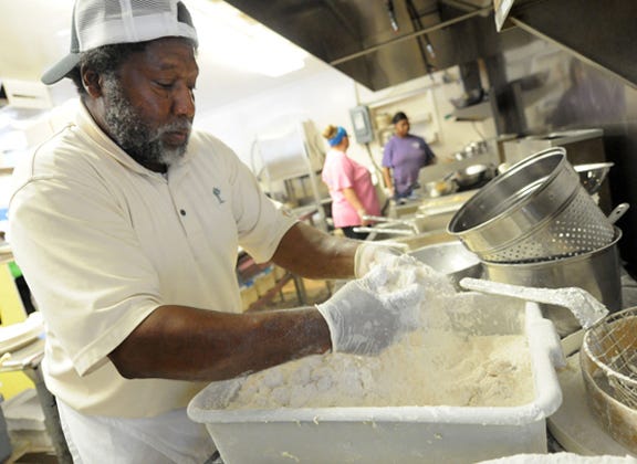 Andy Gause breads shrimp in the kitchen of the Calabash Seafood Hut in Calabash on Sept. 17. Gause has been working in the restaurant for the past 14 years.