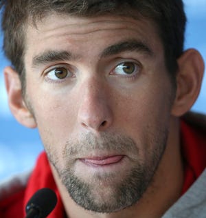 FILE - In this Aug. 20, 2014, file photo, U.S. swimmer Michael Phelps attends a press conference ahead of the Pan Pacific swimming championships in Gold Coast, Australia. Authorities say Phelps has been arrested on a DUI charge in Maryland. Transit police say they stopped the 29-year-old Phelps at the Fort McHenry Tunnel in Baltimore around 1:40 a.m. Tuesday, Sept. 30, 2014.(AP Photo/Rick Rycroft, File)