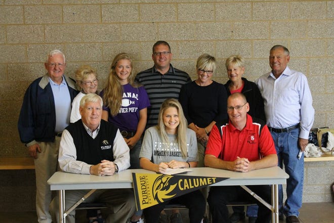 Kaylee Hardy (middle bottom) signs her letter of intent for Purdue University - Calumet. Surrounding her from left to right:

Top: Grandpa Jim Hardy, Grandma Peggy Hardy, sister Ellie, her father John, her mother Amy, Judy Baylis and John Baylis.
Bottom: Coach Tom Megyesi, Kaylee, and Steve Tompkins, head coach of the Saranac girls team.