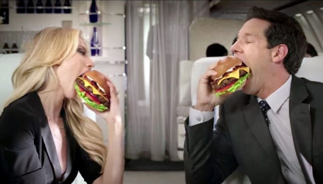 A scene from Hardee's new ad for their Mile High Bacon CheeseThickburger.