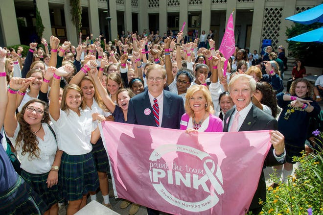 St. Joseph's/Candler Hospital CEO Paul Hinchey, left, and Savannah Morning News Publisher Michael Traynor present a Paint the Town Pink banner to Savannah Mayor Edna Jackson during their breast cancer prevention awareness caravan through Savannah. City information director Bret Bell showed his support with two thumbs up and an appropriately colored wig. johncarringtonphoto.com