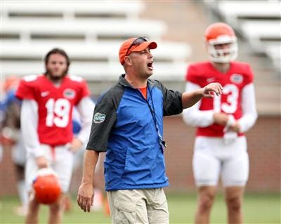 Kurt Roper yells to the quarterbacks during an open practice on the UF campus in Gainesville.