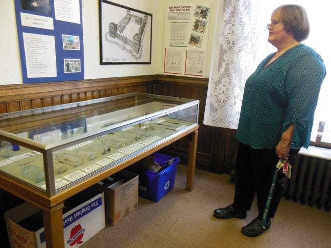 Diana Pett, a volunteer who took part in the summer archaeological dig at the Herkimer County Historical Society, views the new exhibit featuring some of the findings from the dig.

Telegram photo/Donna Thompson