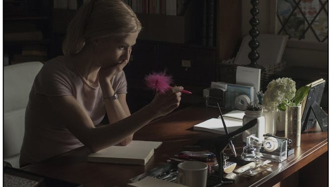 As her marriage flounders, Amy (Rosamund Pike) puts her thoughts down in her diary in “Gone Girl.”
