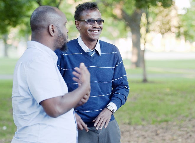 Abdirizak Bihi, right, executive director of the Somali Education and Social Advocacy Center, and Ahmed Ismail, who runs the West Bank Athletic Club, work together as they look out for kids who might be approached in local parks to be recruited to fight in overseas conflicts, in Minneapolis. They walk around in parks near a large Somali community in the Cedar Riverside neighborhood so the kids get to know and trust them. AP PHOTO/CRAIG LASSIG