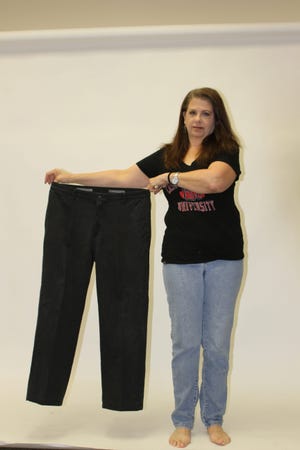 Teri Miles of Stroudsburg shows off her weight-loss success via a pair of pants she wore before starting the Biggest Winner Challenge.
