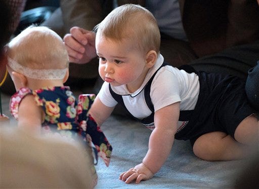 FILE - In this Wednesday, April 9, 2014 file photo, Britain's Prince George, right, plays during a visit to Plunket nurse and parents group at Government House in Wellington, New Zealand. Prince William and his wife Kate are threatening to take legal action against a photographer they say has been monitoring their toddler son Prince George. The palace said Thursday, Oct. 2, 2014 the couple had "taken legal steps to ask that an individual ceases harassing and following both Prince George and his nanny as they go about their ordinary daily lives." In a statement, the palace said the unnamed photographer was suspected of "placing Prince George under surveillance." William and Kate, who are expecting their second child, want to spare their children intense press coverage. (AP Photo/Marty Melville, Pool, file)