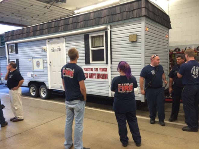 Ottsville Fire Co. members take a look at the fire prevention trailer at Friday's Fire Prevention Week Open House event.