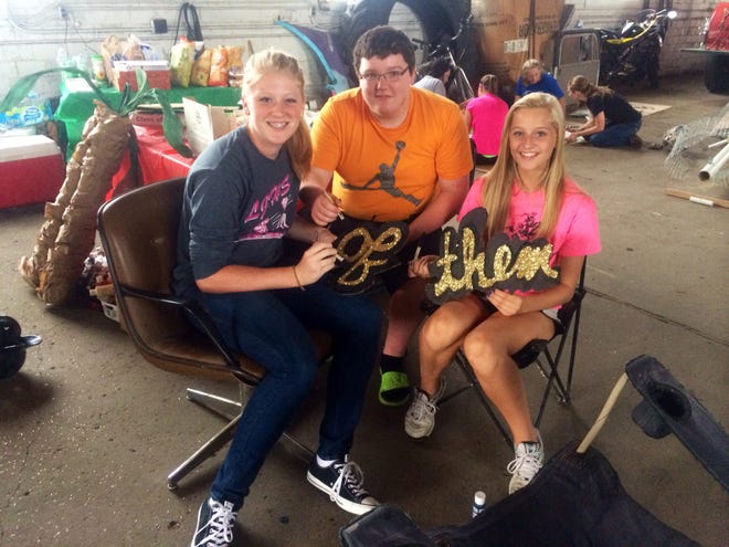 Lincoln Community High School Freshmen Ariana Spencer, Anthony Brummett and Adriana Doolin posed for a quick photo Wednesday after school as they and their classmates worked on an Egypt themed float for the 2014 Homecoming Parade. Photo by Jessica Lema/The Courier.