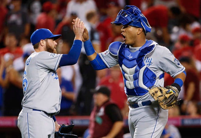 Kansas City Royals catcher Salvador Perez, right, celebrates with relief pitcher Greg Holland after the Royals defeated the Los Angeles Angels 3-2 in 11 innings in Game 1 of baseball's AL Division Series in Anaheim, Calif., Thursday, Oct. 2, 2014. (AP Photo/Lenny Ignelzi)