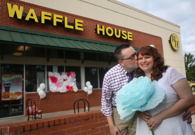 Ken Foote kisses his wife Summer Buckles after their wedding in front of the Waffle House on US 441 on Friday in Gainesville.