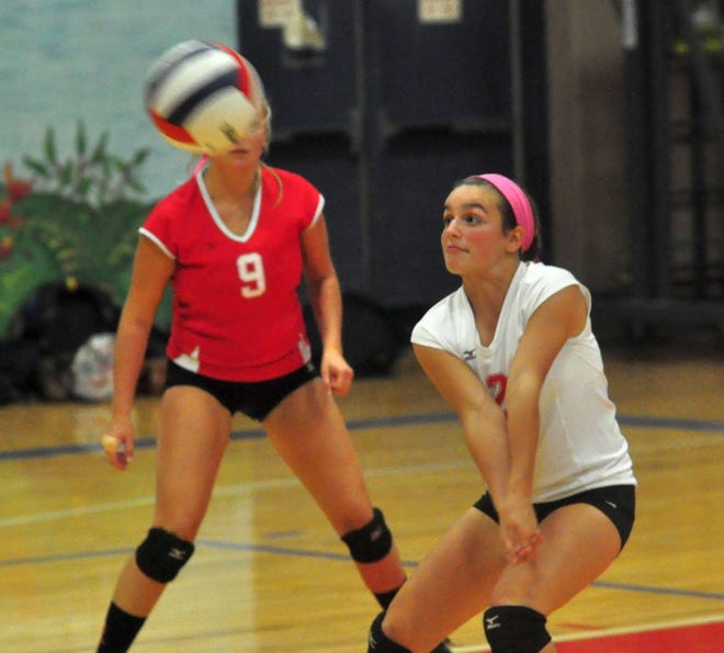 Spaulding’s Madison Provencher, right, handles a Dover serve as teammate Casey Ford looks on during Division I action Friday night in Rochester.
