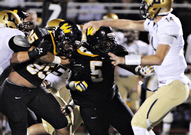 Archbishop Wood's Christian Lohin (85) and Devon Cobb (5) hard blocked as they try to sack La Salle quarterback Kyle Shurmur (14) at William Tennent High School Friday night.