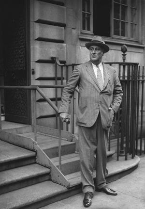 In this 1933 file photo, President Franklin Delano Roosevelt stands in front of the town house he and his wife, Eleanor, owned on the Upper East Side in New York. The home is now owned by Hunter College and can be toured by the public. ASSOCIATED PRESS